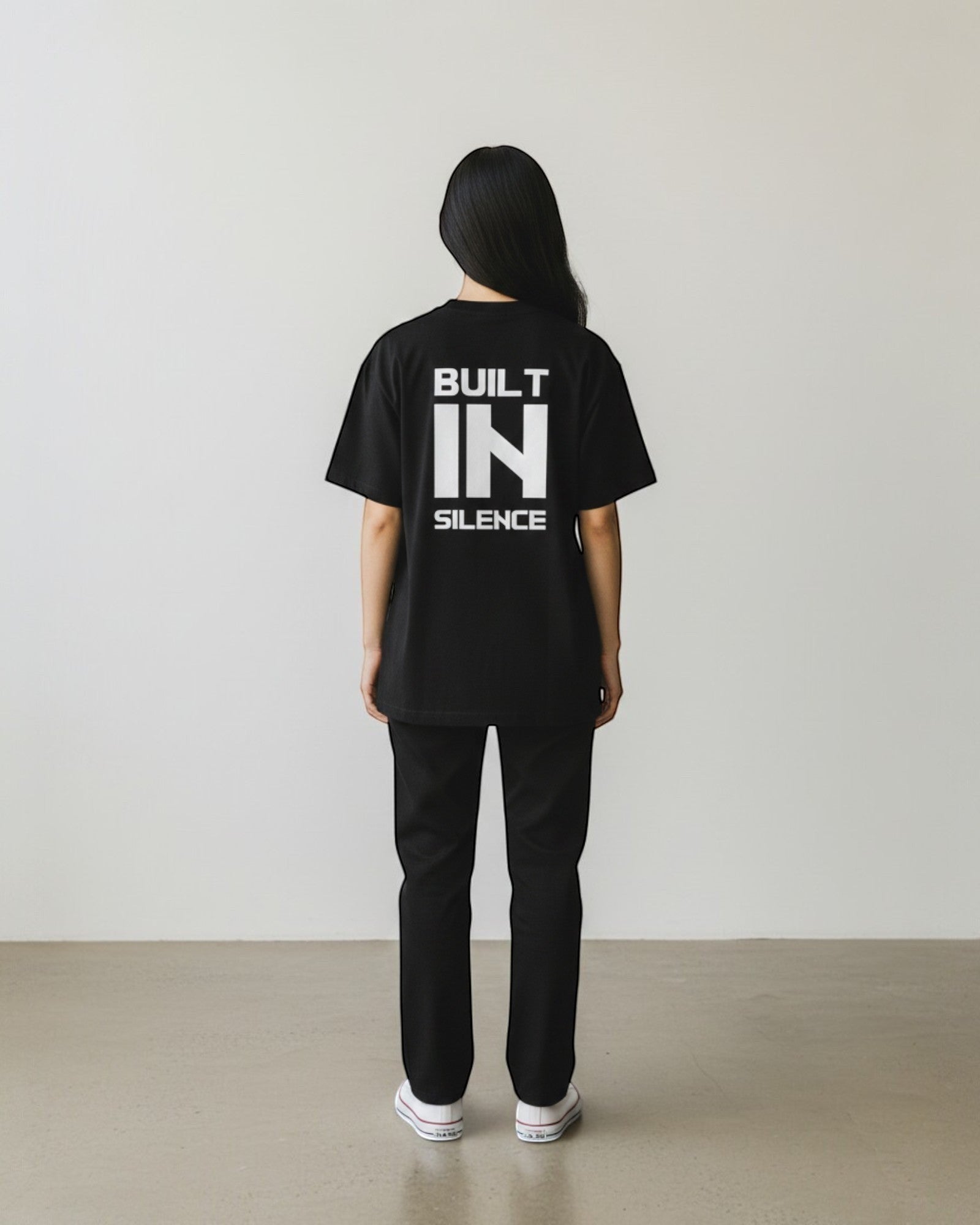 FALLR wear black 100% cotton oversized t-shirt with white "BUILT IN SILENCE" graphic print on back.
