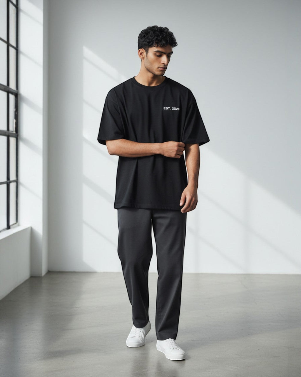 FALLR wear black 100% cotton oversized t-shirt with minimalist 'EST. 2026' graphic, worn by a man.