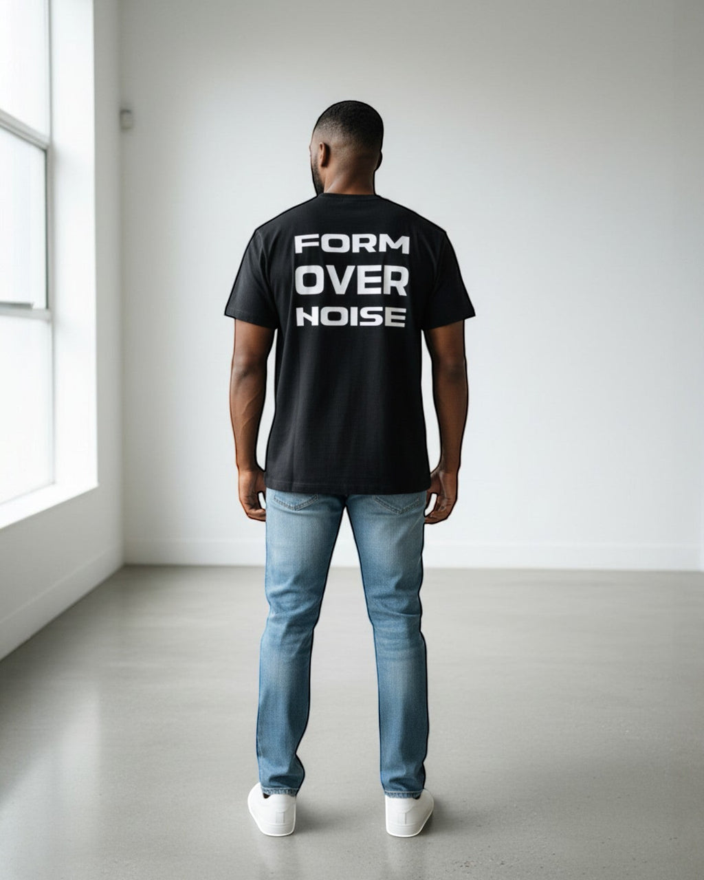 FALLR wear black 100% cotton t-shirt with white 'FORM OVER NOISE' graphic print on back, worn by a man with jeans.