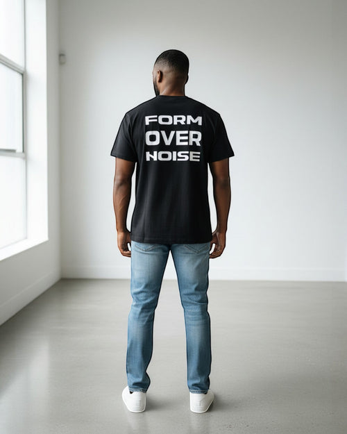 FALLR wear black 100% cotton t-shirt with white 'FORM OVER NOISE' graphic print on back, worn by a man with jeans.
