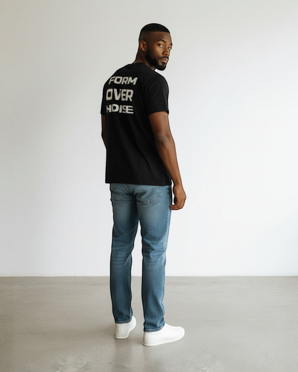 FALLR wear black 100% cotton t-shirt with 'FORM OVER NOISE' graphic print on back, worn by a man with jeans.