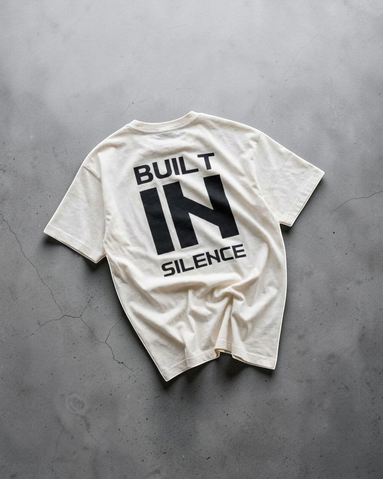 FALLR wear cream 100% cotton oversized graphic t-shirt with "BUILT IN SILENCE" text print on back.