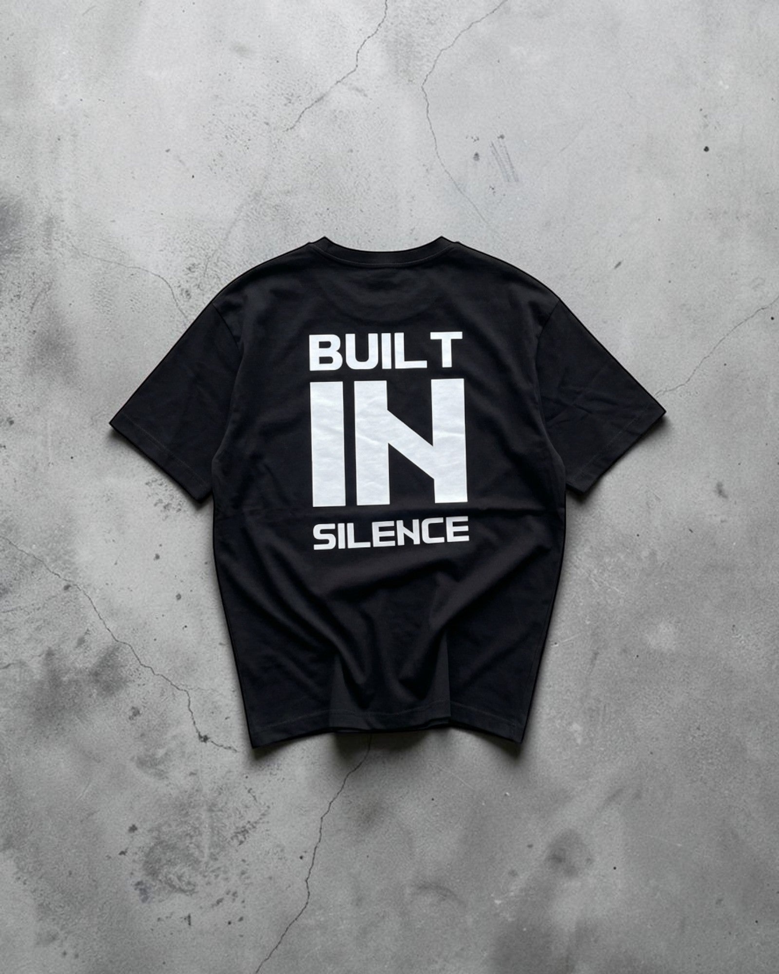FALLR wear black 100% cotton t-shirt with "BUILT IN SILENCE" graphic print on back. Relaxed fit, unisex streetwear.