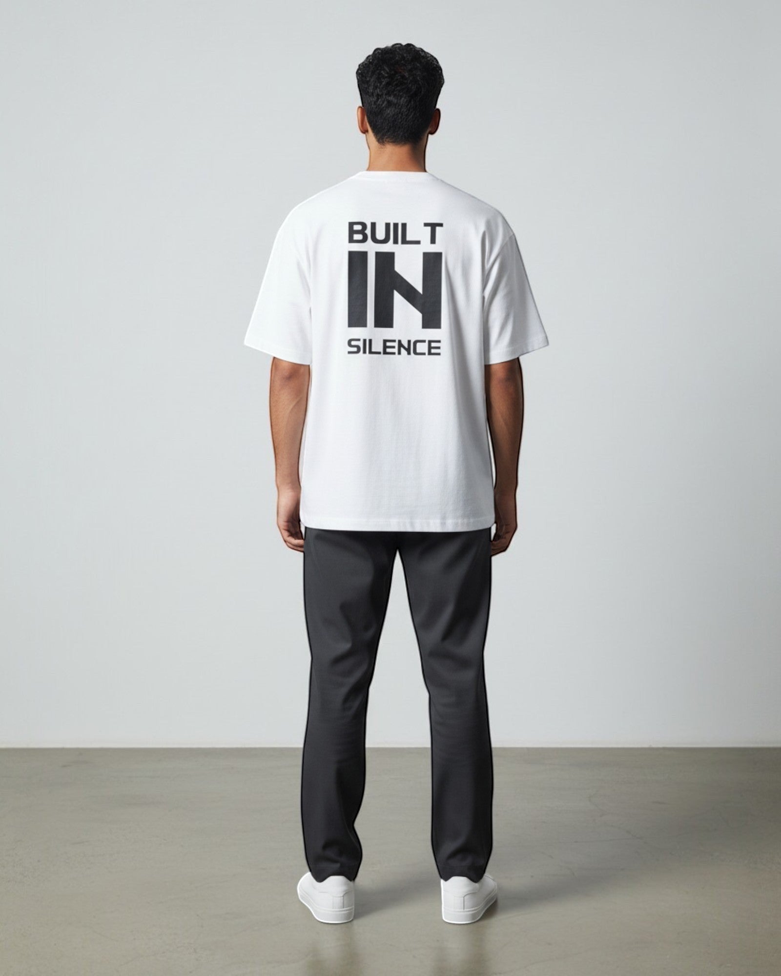 FALLR wear white 100% cotton oversized t-shirt with black "BUILT IN SILENCE" graphic on back. Unisex streetwear.