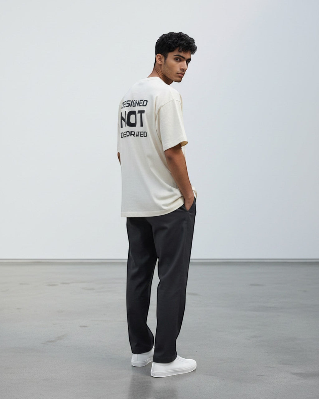 FALLR wear cream 100% cotton unisex oversized t-shirt with black 'Designed Not Decorated' graphic print on back.