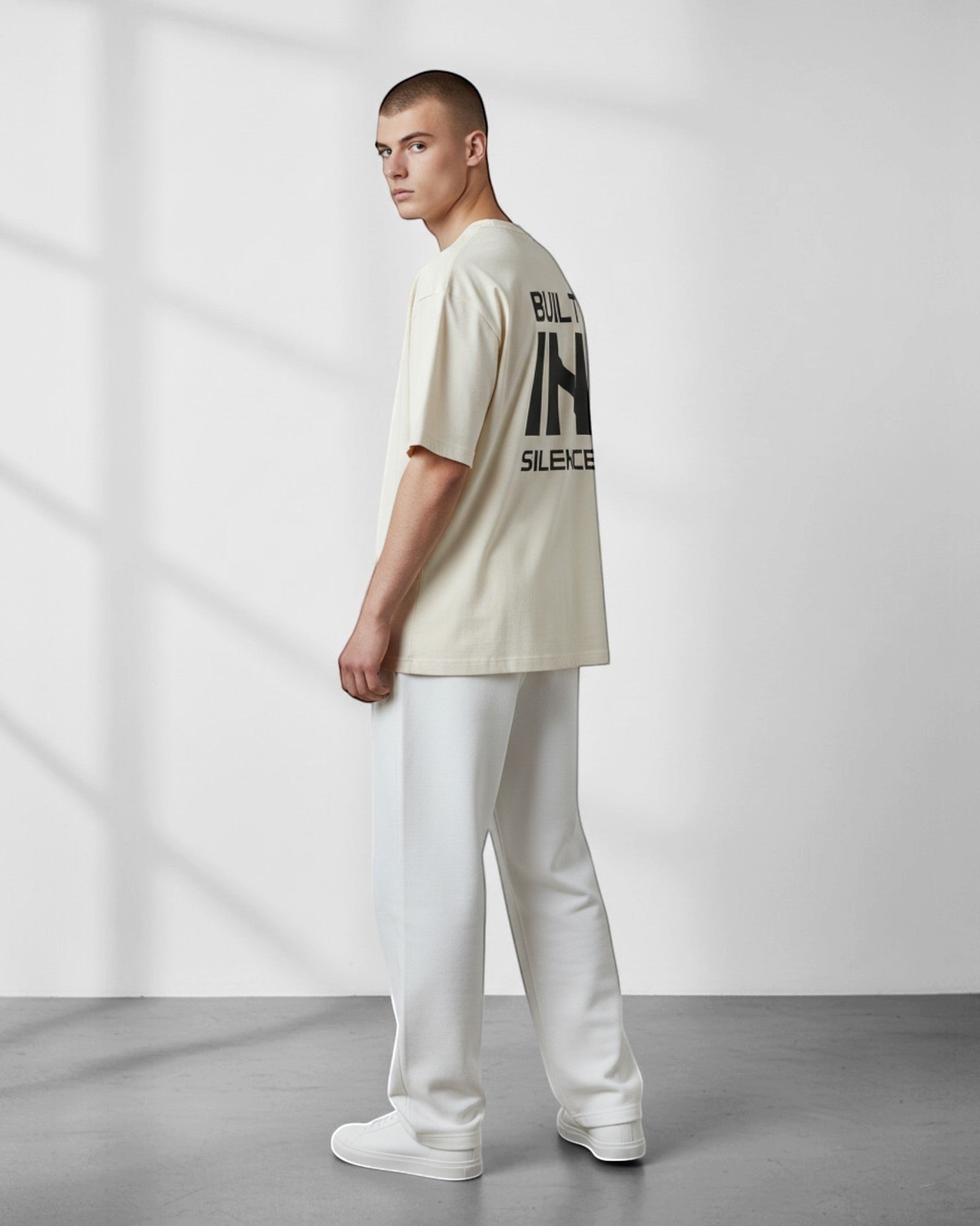 FALLR wear men's oversized cream 100% cotton t-shirt with black "BUILT IN SILENCE" graphic on back.