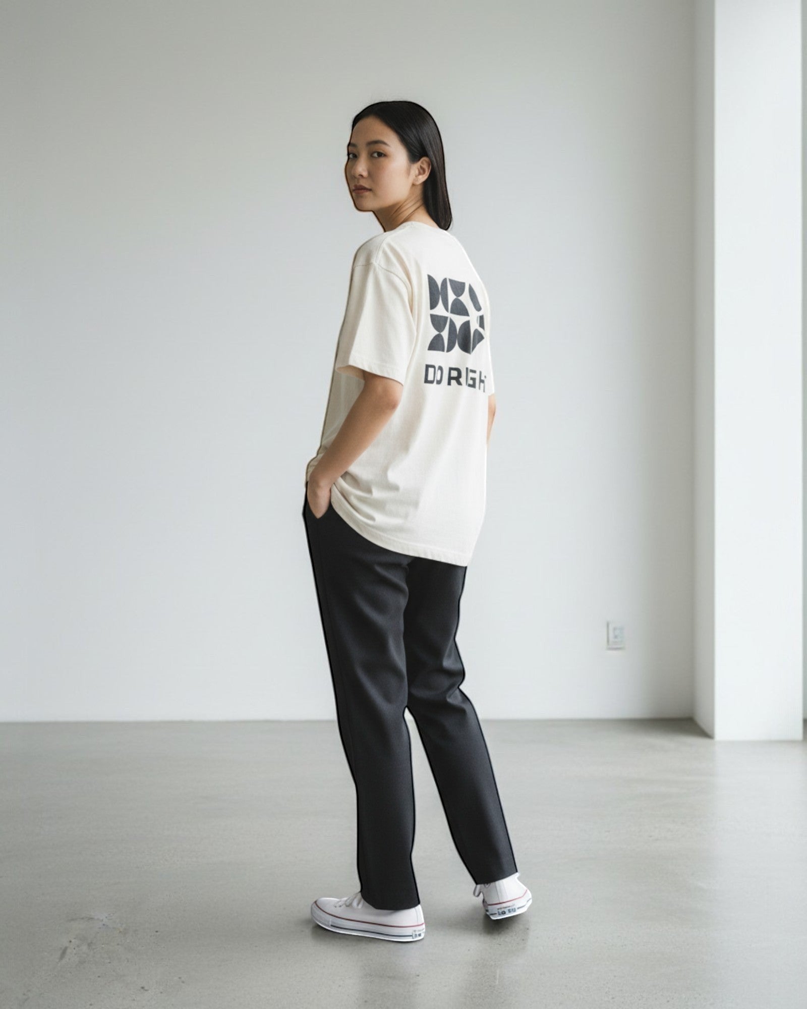 FALLR wear cream 100% cotton oversized graphic tee with black geometric print and text "DO RIGHT". Model wears black trousers.