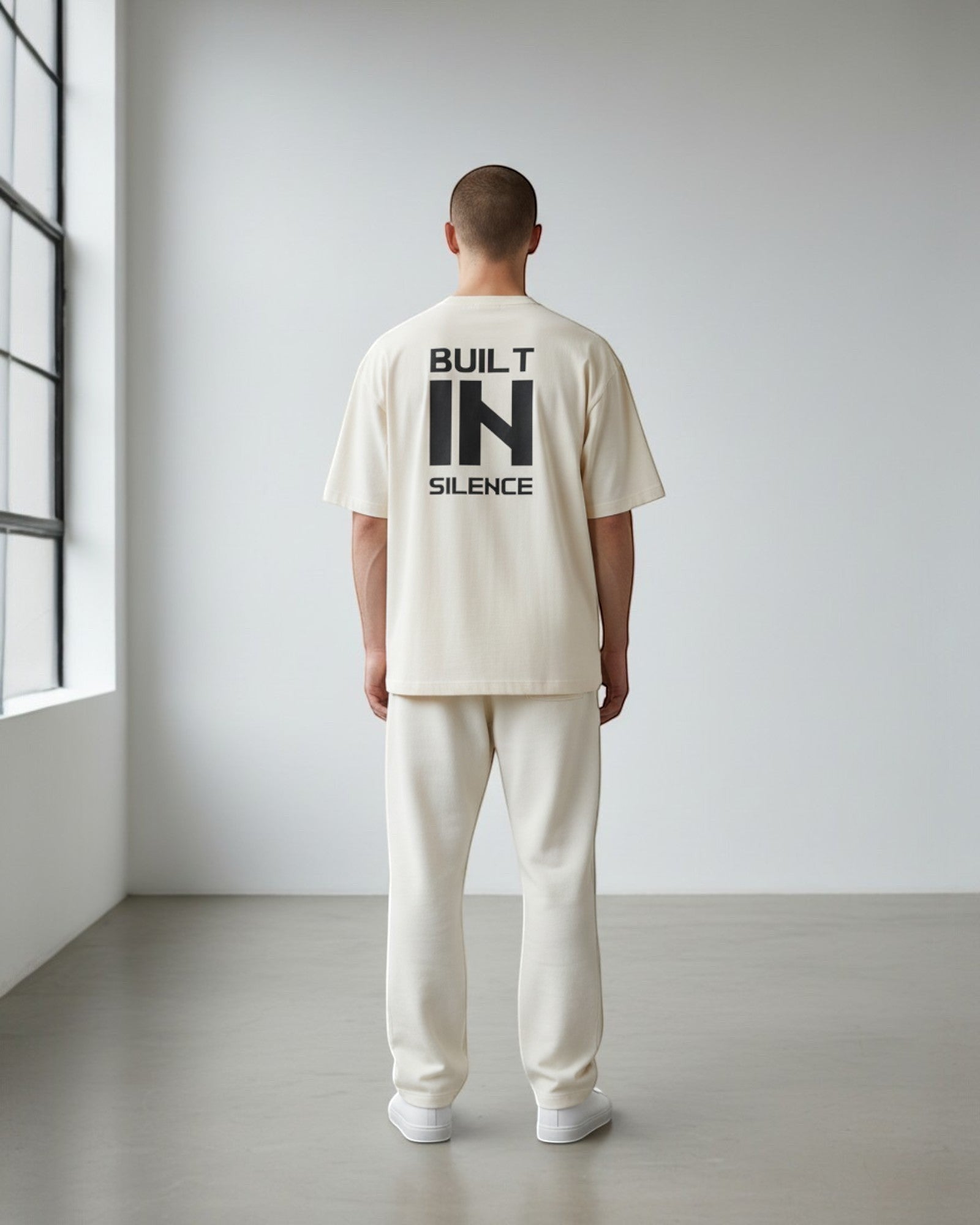 FALLR wear men's oversized cream 100% cotton t-shirt with black 'BUILT IN SILENCE' graphic on back.