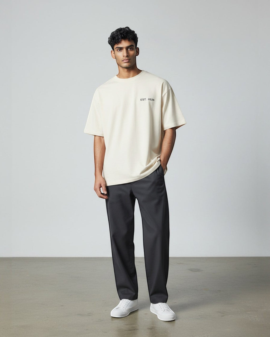 FALLR wear men's cream 100% cotton oversized t-shirt with 'EST. 2026' graphic, paired with dark grey trousers.