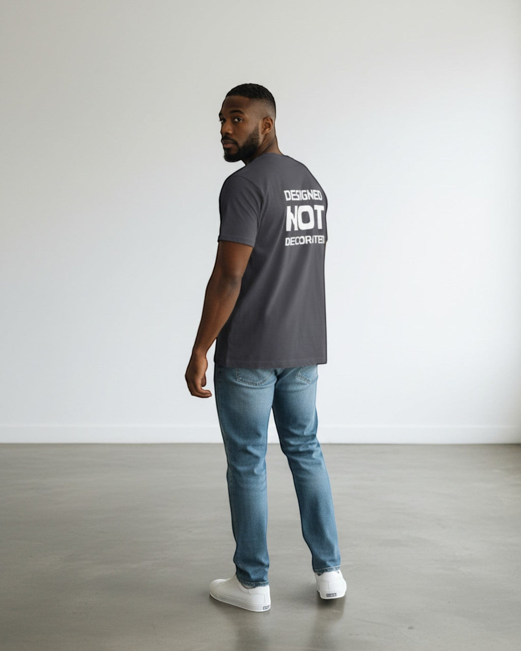 FALLR wear dark grey 100% cotton unisex oversized t-shirt with white 'DESIGNED NOT DECORATED' graphic on back.