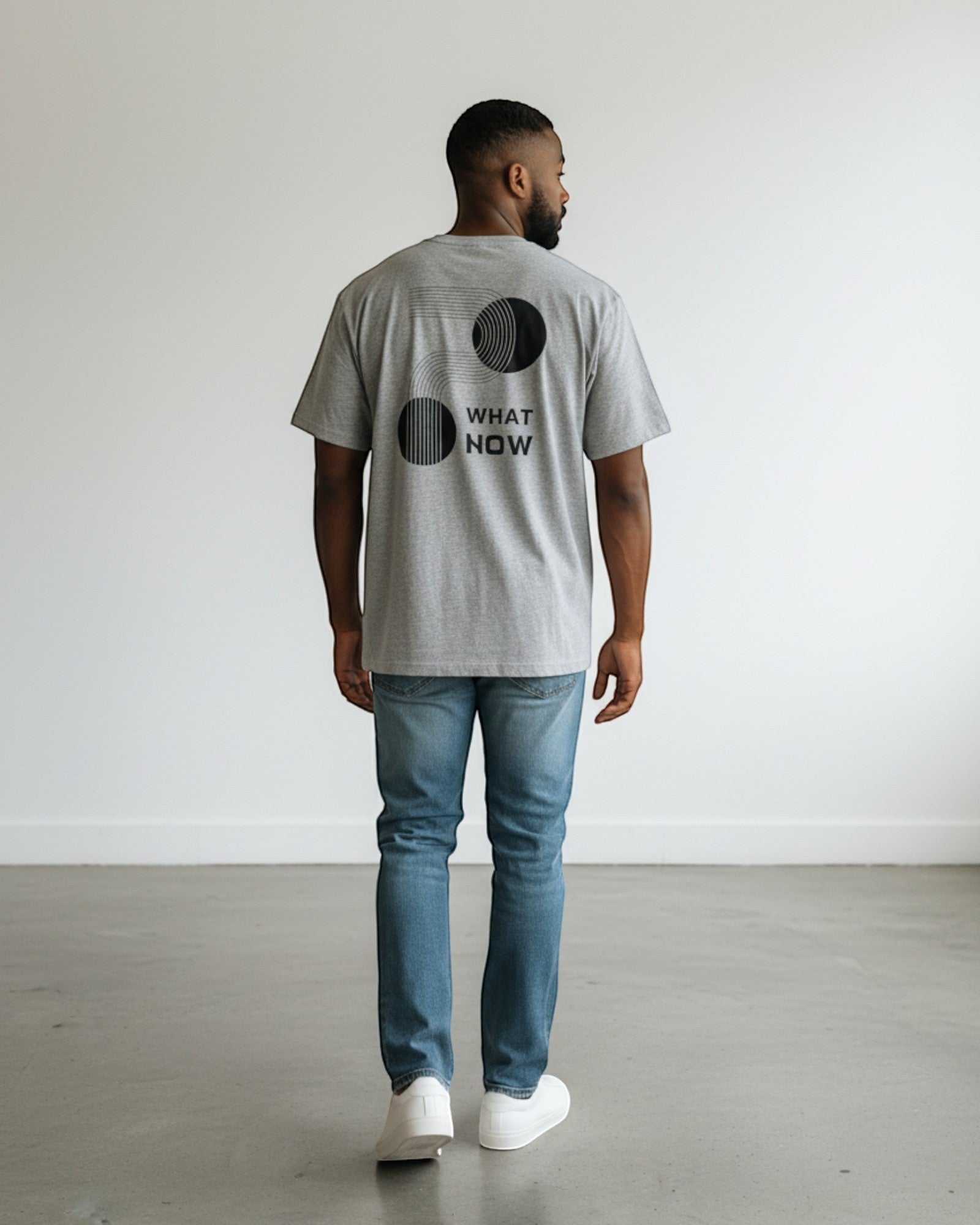 FALLR wear grey 100% cotton oversized t-shirt with black geometric 'What Now' graphic print on back.