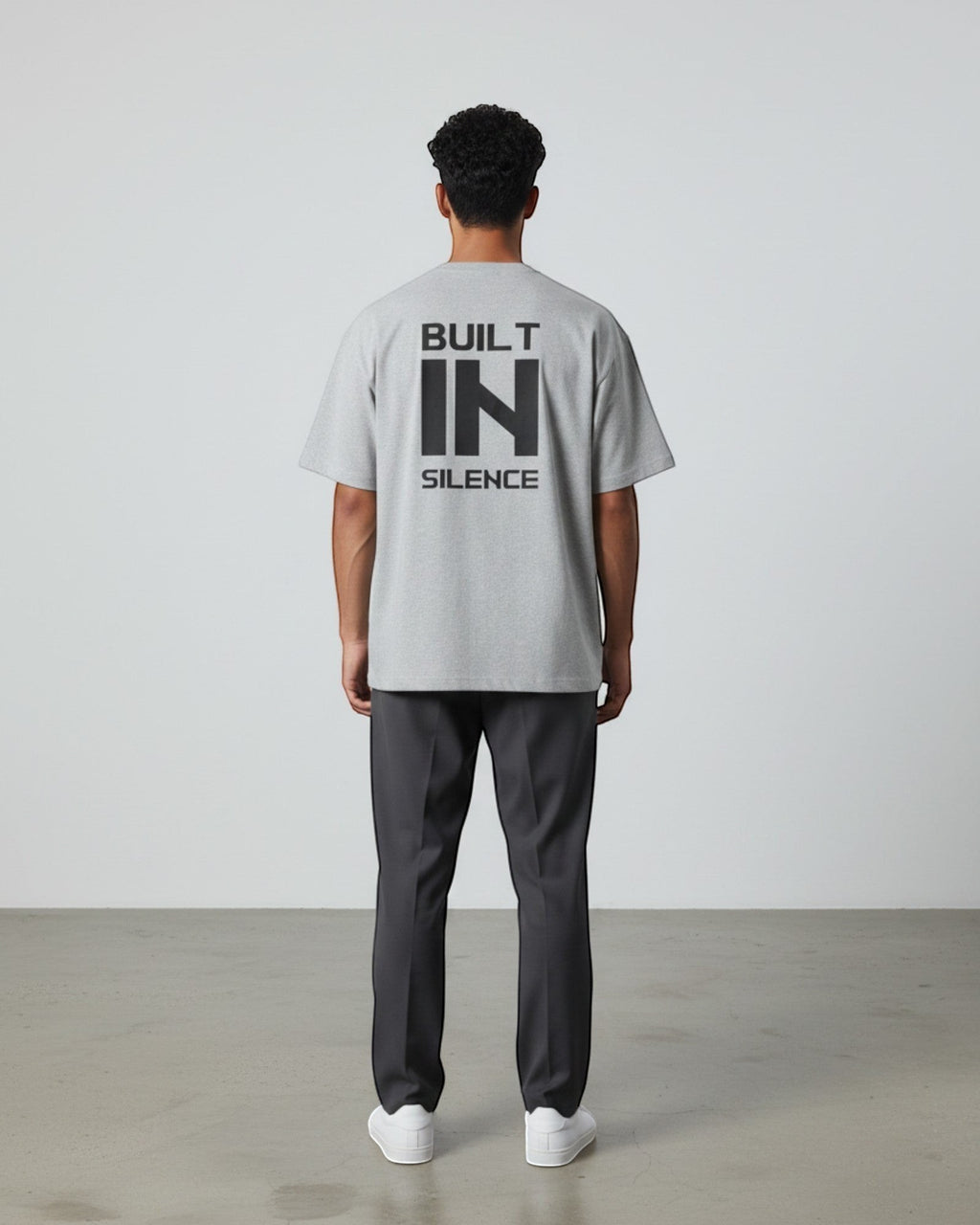 FALLR wear grey 100% cotton oversized t-shirt with black "BUILT IN SILENCE" graphic print on back.