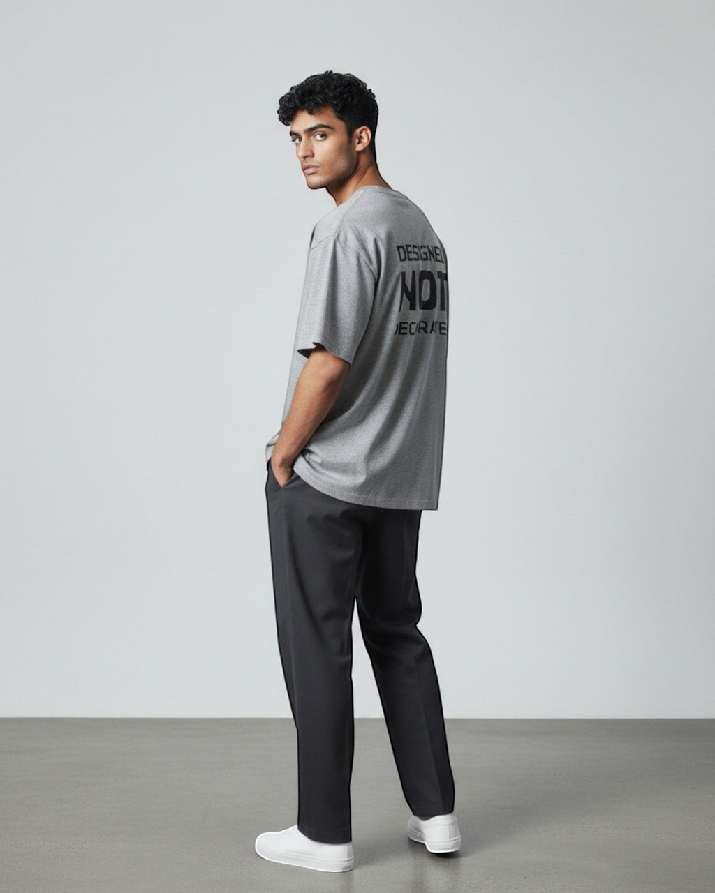 FALLR wear grey 100% cotton oversized unisex t-shirt with black 'Designed Not Decorated' graphic print on back.