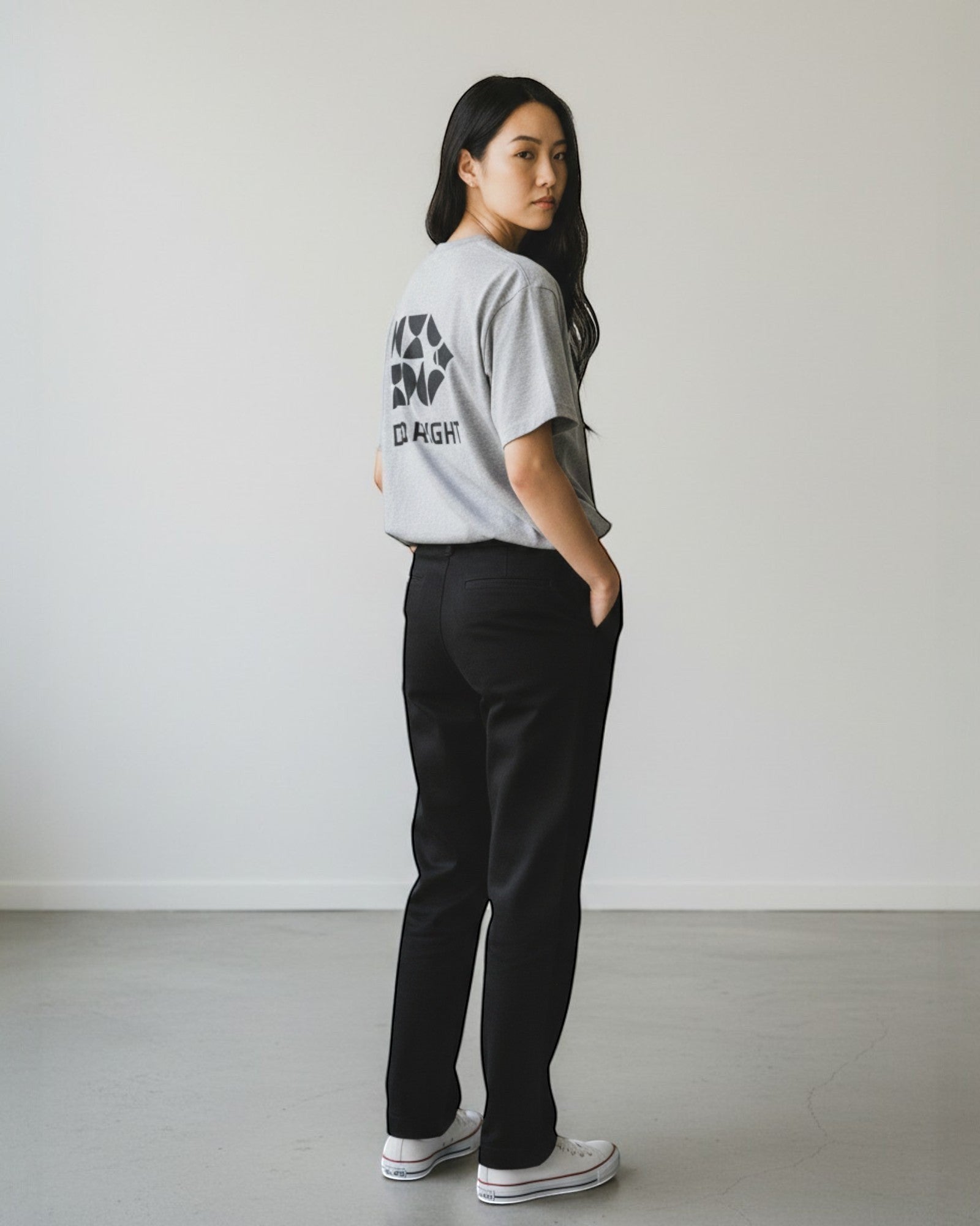 FALLR wear grey 100% cotton oversized t-shirt with black graphic print on back, paired with black trousers.