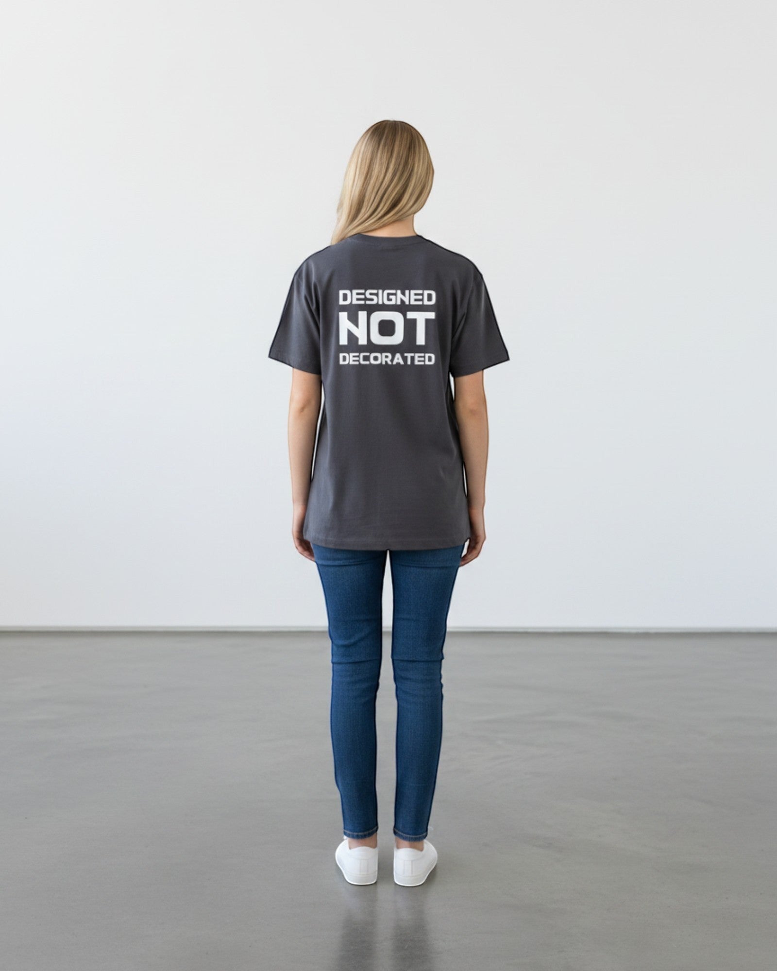 FALLR wear dark grey 100% cotton unisex oversized t-shirt with 'DESIGNED NOT DECORATED' graphic print on back.