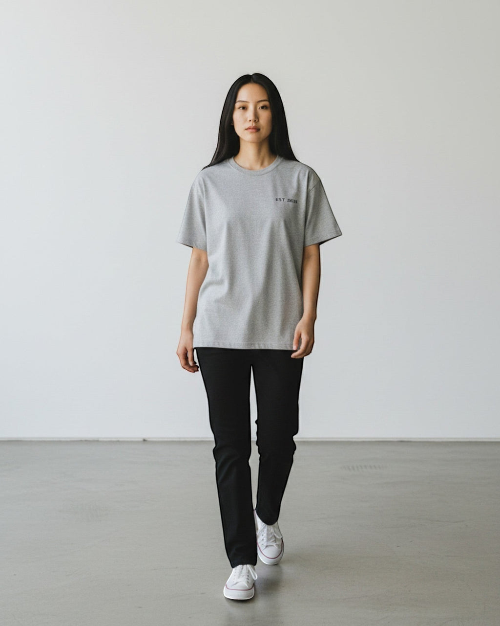 FALLR wear grey 100% cotton oversized t-shirt with minimal black graphic print on chest, worn by a woman.