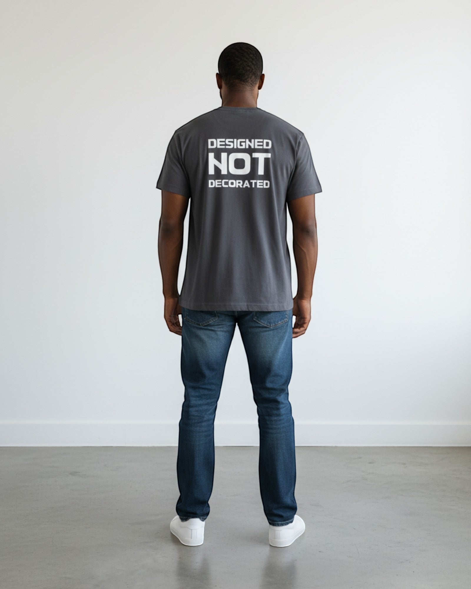 FALLR wear men's dark grey 100% cotton oversized t-shirt with 'DESIGNED NOT DECORATED' graphic on back.