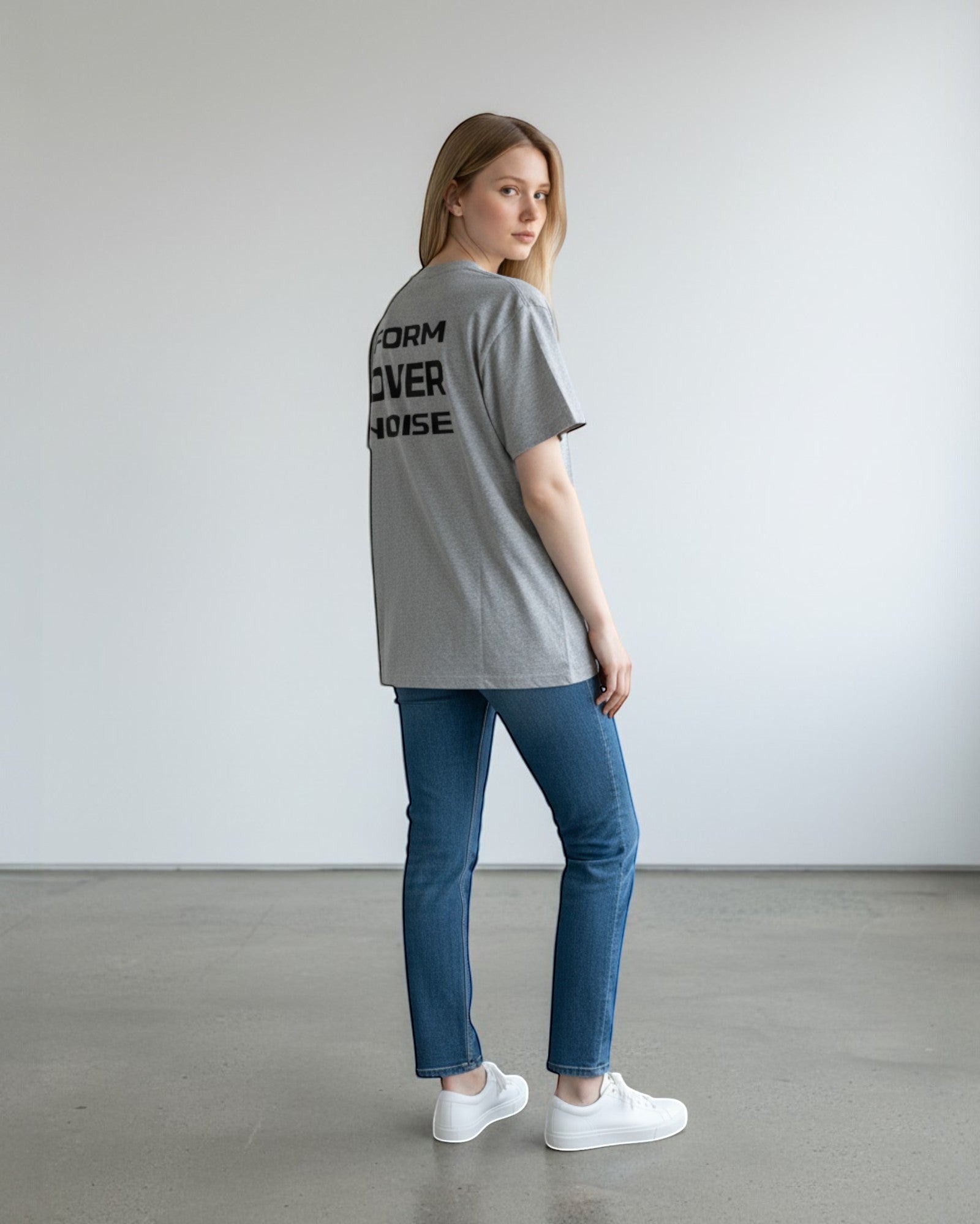 FALLR wear grey 100% cotton oversized t-shirt with black 'FORM OVER NOISE' graphic print on back, worn by a woman.