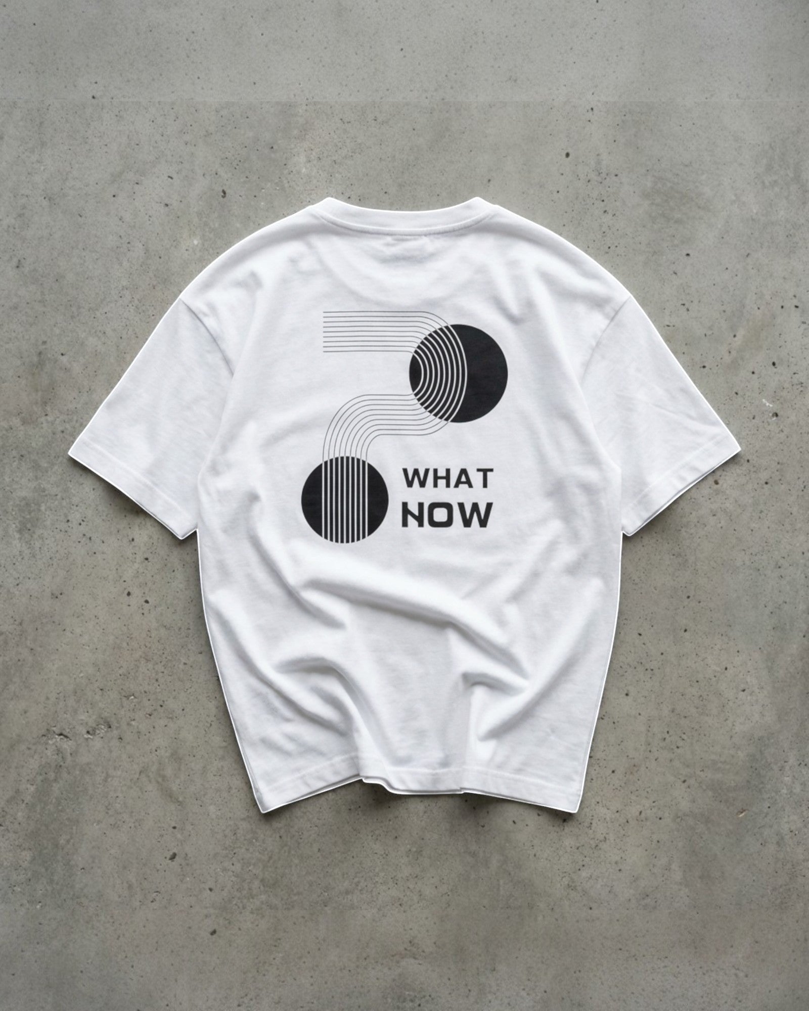 FALLR wear white 100% cotton t-shirt with black geometric graphic print and "WHAT NOW" text. Unisex, relaxed fit.