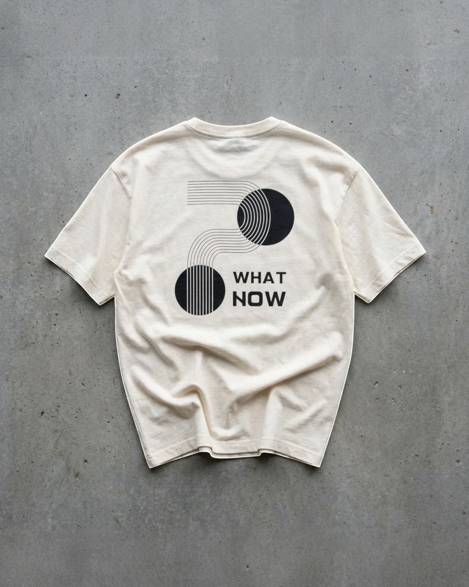 FALLR wear cream 100% cotton t-shirt with black graphic print and "What Now" text, relaxed fit, unisex streetwear.