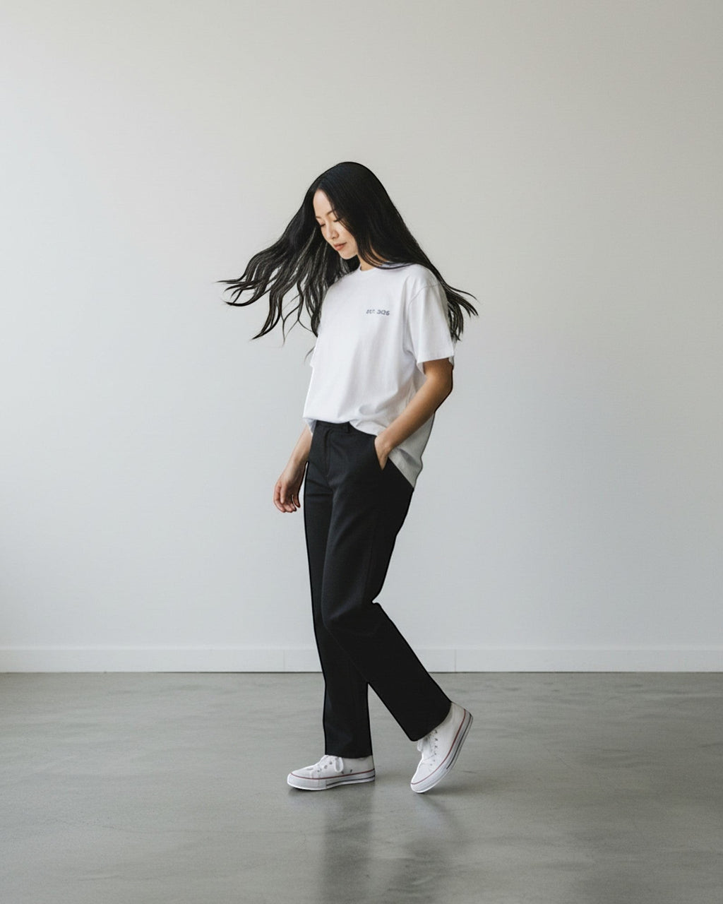 FALLR wear white 100% cotton oversized t-shirt with minimalist graphic print, worn by a woman with black hair.