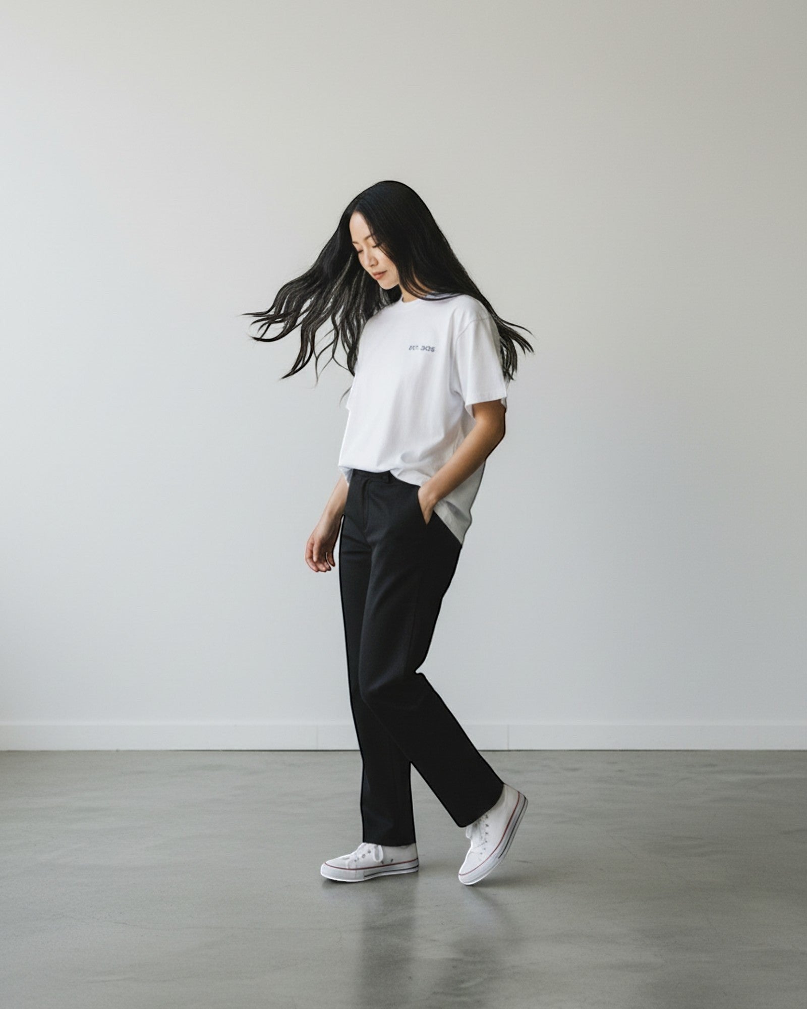 FALLR wear white 100% cotton oversized t-shirt with minimalist graphic print, worn by a woman with black hair.