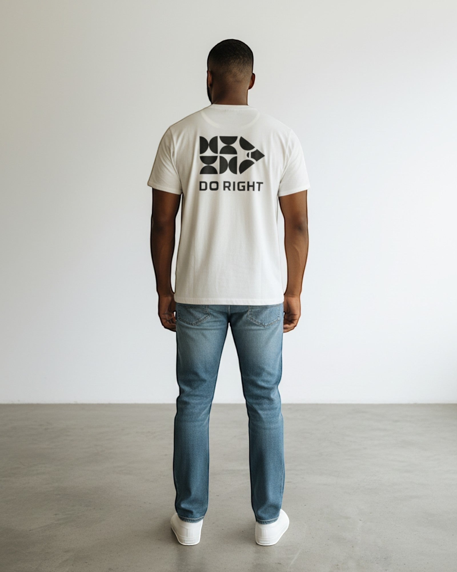 FALLR wear white 100% cotton oversized graphic tee with black "DO RIGHT" print on back. Model is wearing jeans.